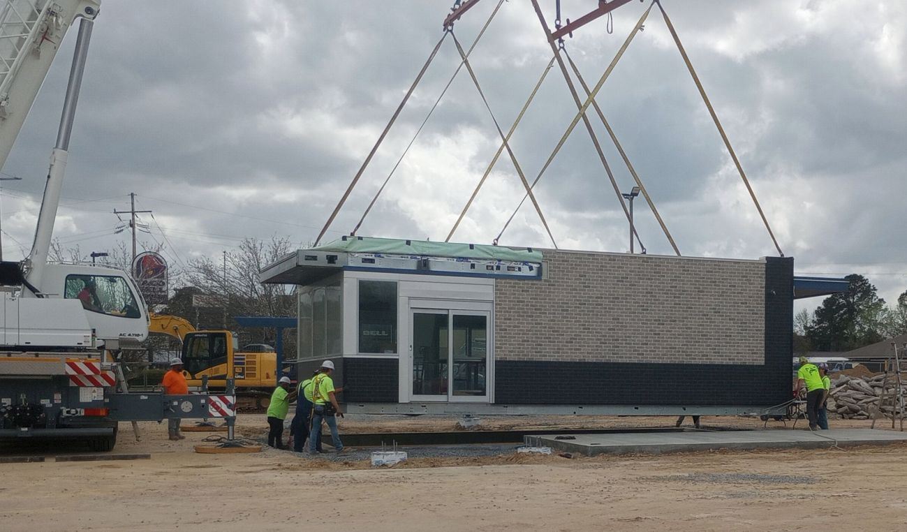 Placing the 7 Brew Coffee modular building in place.
